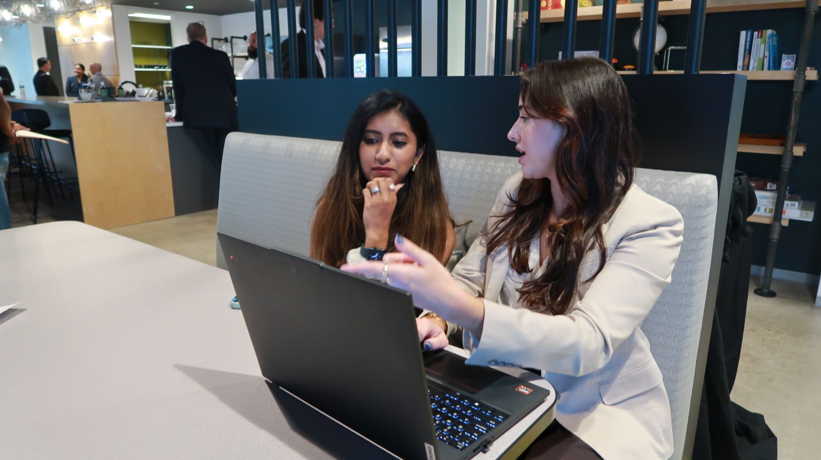 Two Hive team members working together on a laptop